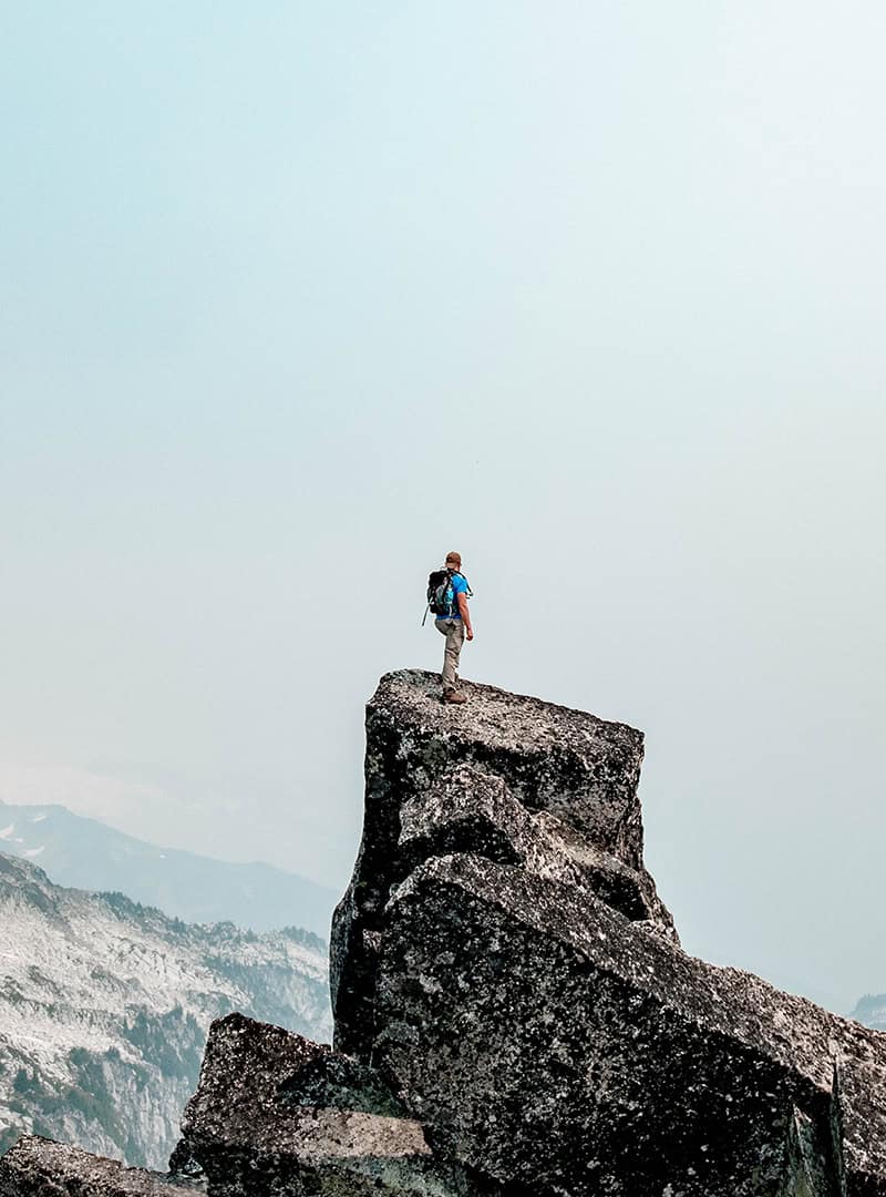 Ein Bergsteiger auf der Spitze eines Felsens