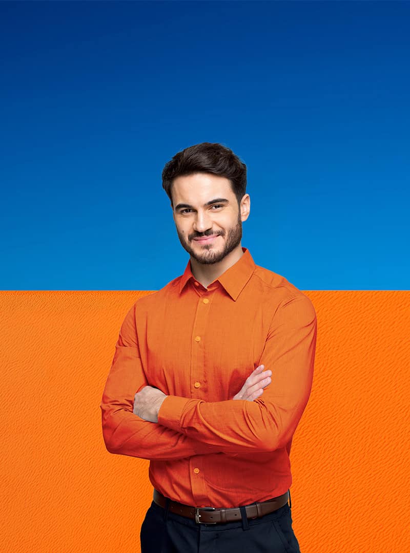 Ein sympathischer, lächelnder, junger Mann vor einem blau/orangefarbenen Hintergrund.